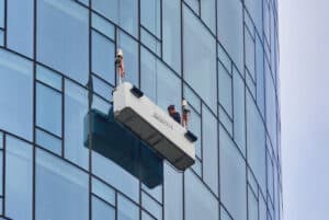 A man Facade Cleaning a building