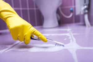 A person doing a deep cleaning on the floor tiles.